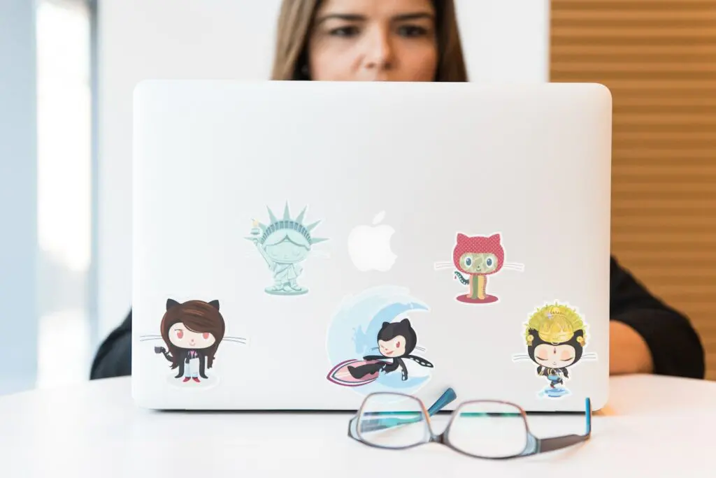 woman using laptop with octopus stickers