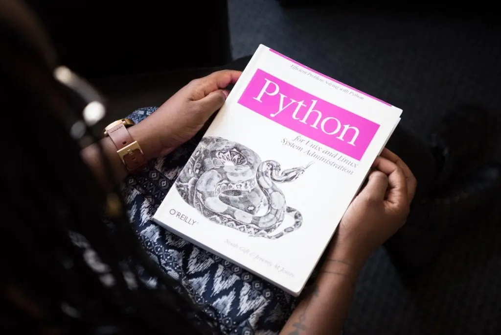 woman holding a Python book